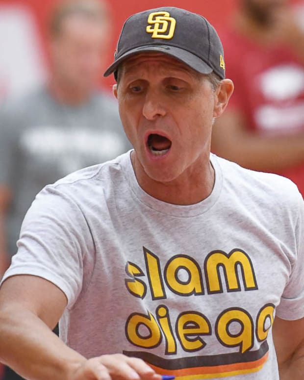 Arkansas coach Eric Musselman, wearing his San Diego Padres' gear, yells instructions at Wednesday's practice as the Razorbacks get ready for European exhibition games.
